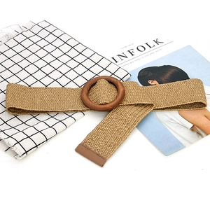 Detail of beige elastic woven belt featuring a round wooden buckle and brown leather trim
