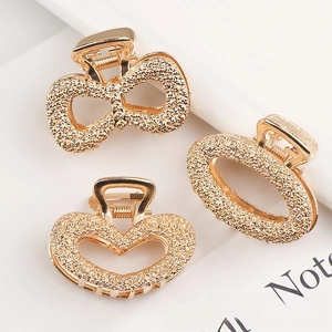 Three-piece gold alloy hair claw set featuring rose patterns and butterfly designs