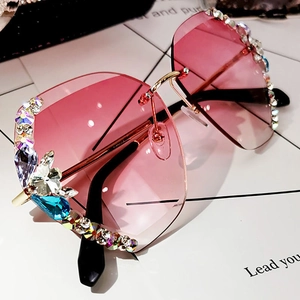 Pink gradient oversized rimless sunglasses with colorful rhinestones on white background