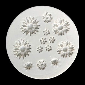 White daisy silicone mold for fondant and crafts with twelve flower cavities on black background