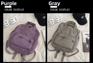 Detail shot of canvas backpack in purple and gray with durable texture and front pocket