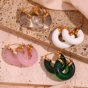 Chic acrylic hoop earrings in four colors on stone and satin background details