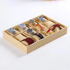 Detail of 12-slot beige velvet watch display tray with removable jewelry pillows