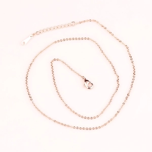 Detail of rose gold box chain featuring a secure lobster clasp and adjustable tail chain