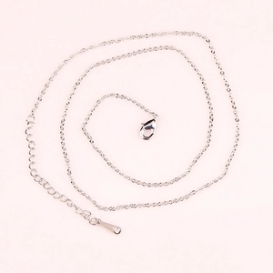 Polished silver copper chain necklace with lobster clasp and extension on pink background