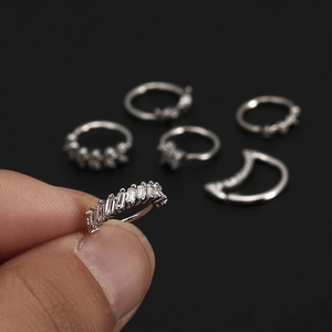 Nose rings set with star, moon and flower zircon studs in silver-toned polished metal