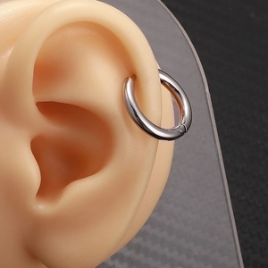 Classic silver stainless steel hoop earrings for women shown on a professional ear model
