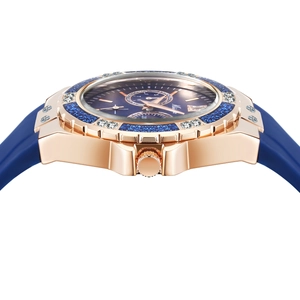 Detail view of rose gold watch case with diamond bezel and blue silicone strap