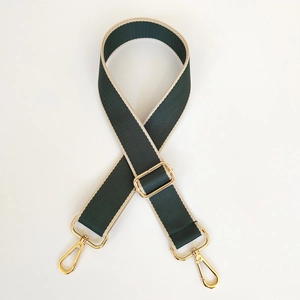 Detail of green and beige striped 3.8cm wide fabric strap with gold metal hooks
