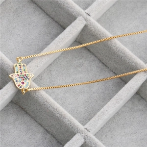 Golden Hamsa Hand necklace with colorful zircon Evil Eye pendant in a jewelry box