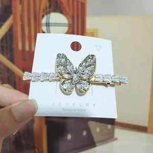Close-up of butterfly crystal hair clip with sparkling rhinestones and gold-tone alloy base