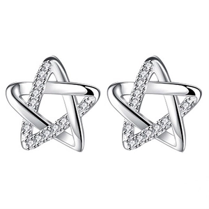 Macro shot of silver hollow star earrings with sparkling diamonds on white background