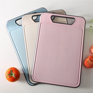 Three-piece wheat straw cutting board set in pink, beige, and blue with anti-slip texture