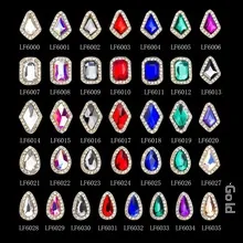 Flat lay of 36 assorted gold-rimmed nail art rhinestones with colorful glass crystals