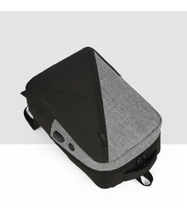 Top view of two-tone oxford backpack with integrated USB charging port and zipper detail