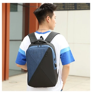 Blue and black oxford laptop backpack featuring external USB charging port on the side