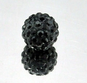 Macro shot of a black 8mm Shamballa disco clay bead with sparkling faceted rhinestones
