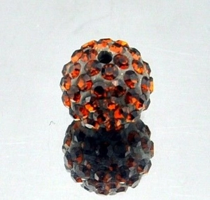 Detailed macro of 8mm amber clay pavé disco ball bead with sparkling rhinestones