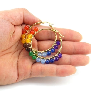 Handcrafted gold hoop earrings featuring rainbow natural stones and intricate wire wrap