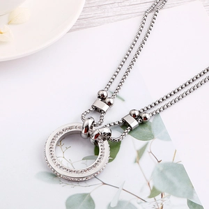 Double-layered silver necklace with a sparkling round diamond-set circular pendant