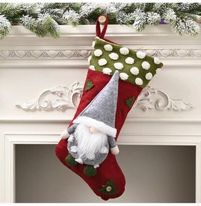 Detail of a 20-inch plush Christmas gnome stocking hanging on a festive mantelpiece