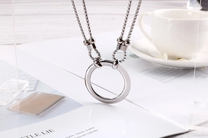 Detail of silver double-layered titanium steel necklace with a minimalist round pendant
