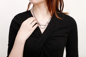 Close-up of double-layer silver titanium steel necklace with elegant oval pendant