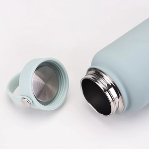 Close-up of a 1L light blue matte insulated bottle showing stainless steel interior and lid