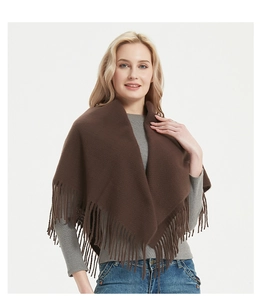 Close-up of soft brown solid color scarf with fringes worn by a model on plain background