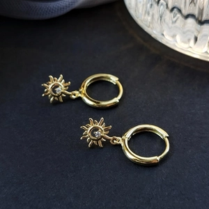 Unisex S925 silver sunburst hoop earrings with sparkling zircon on a black background