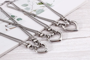 Detailed macro view of the double-layered hollow heart pendants with mirror polished finish
