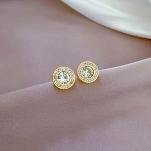 Titanium steel stud earrings with brilliant zircon stones on soft silk background