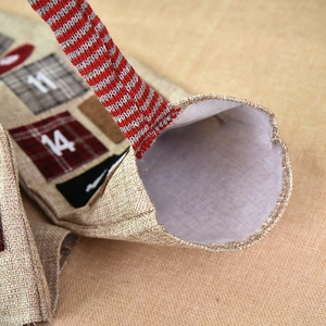 Linen Christmas advent calendar bags with numbered embroidery and striped hanging ropes