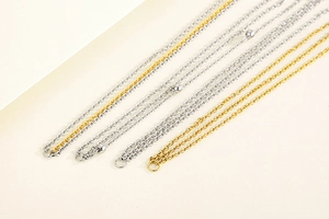 Detail view of multi-layered gold and silver stainless steel chains with metallic beads