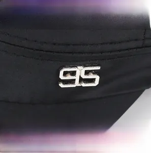 Detail of a black mesh hat featuring a 3D silver metal number 95 emblem with firm stitching