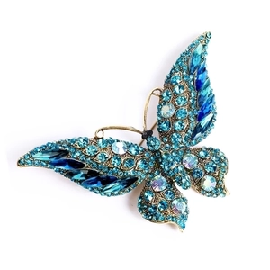 Macro shot of blue crystal butterfly brooch with antique gold metal plating details