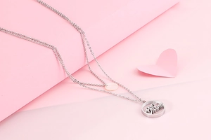 Detail of silver double-layered titanium steel necklace with circular Mum pendant