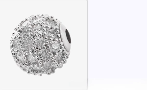 Macro detail of silver pave set 8mm charm bead with sparkling cubic zirconia stones