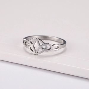Titanium steel ring with Celtic Triquetra and infinity knot on white platform