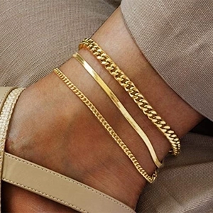 Three-piece layered gold anklet set featuring flat snake and Cuban chain styles
