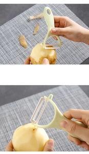 Detail showing a light green peeler removing potato skin and removing sprout eyes