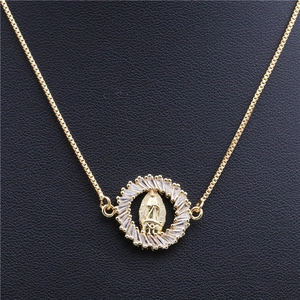 Macro detail of gold-plated copper chain necklace with a zircon-encrusted Virgin Mary medal