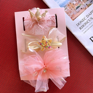 Detailed view of pink lace crown, sequin star, and tulle bow baby headbands in gift set