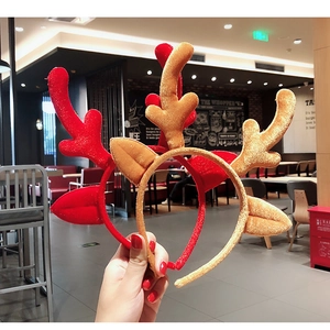 Close-up of plush red and brown Christmas reindeer antler headbands with cute ears