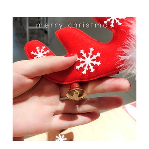 Detail of red felt reindeer antlers with snowflake patterns and small gold bells