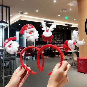 Detail of plush Christmas headbands featuring Santa Claus and reindeer with springs