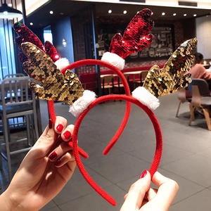 Close-up of sparkling red and gold sequin reindeer antler headbands for Christmas party