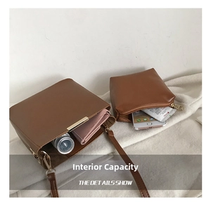 Internal capacity of brown leather bucket bag showing phone and essentials with small pouch