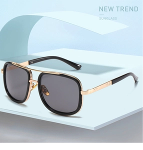Detail of trendy oversized metal double-bridge sunglasses on a light blue display stand
