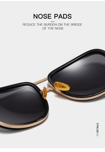 Detailed close-up of golden nose pads and textured metal frame on stylish black sunglasses